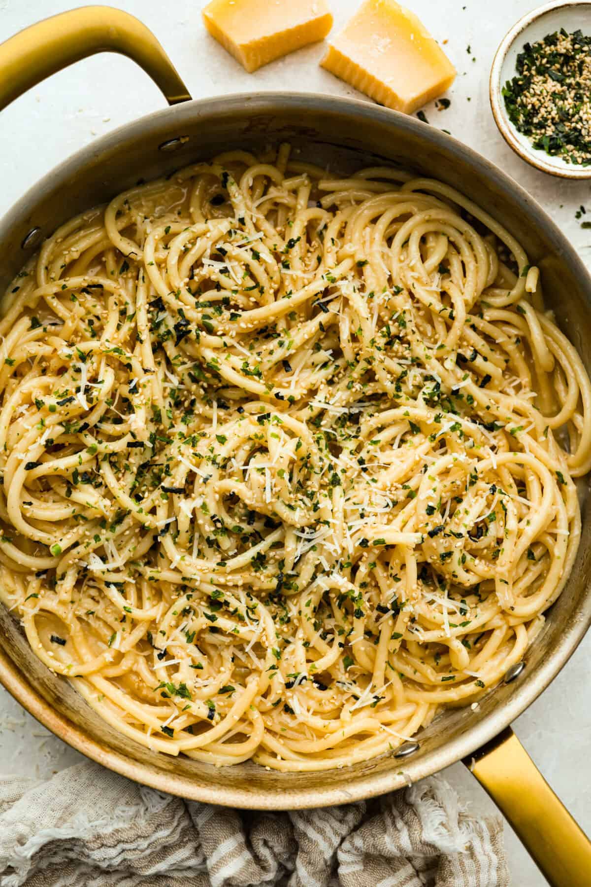 Overhead shot of a skillet full of miso pasta garnished and ready to eat.