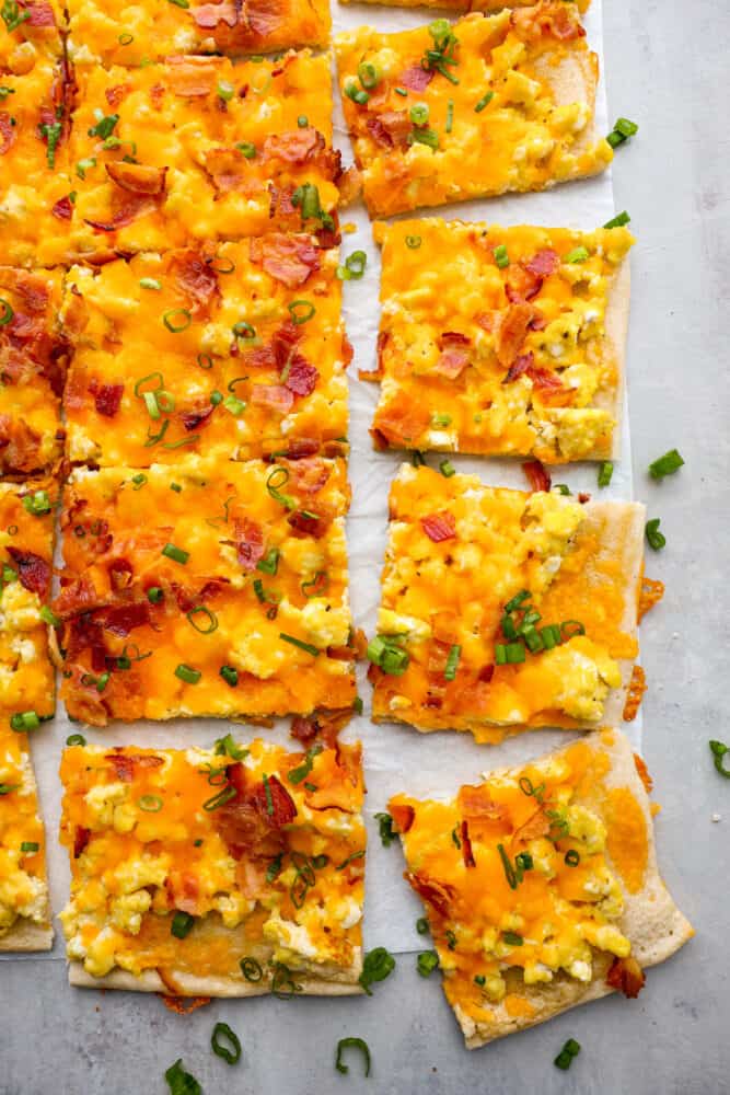 Top-down view of breakfast pizza cut into slices.