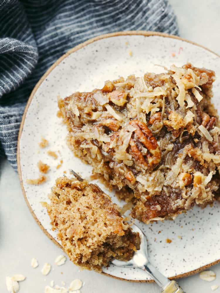 The top view of a square of oatmeal cake on a plate with a fork cutting into it, 