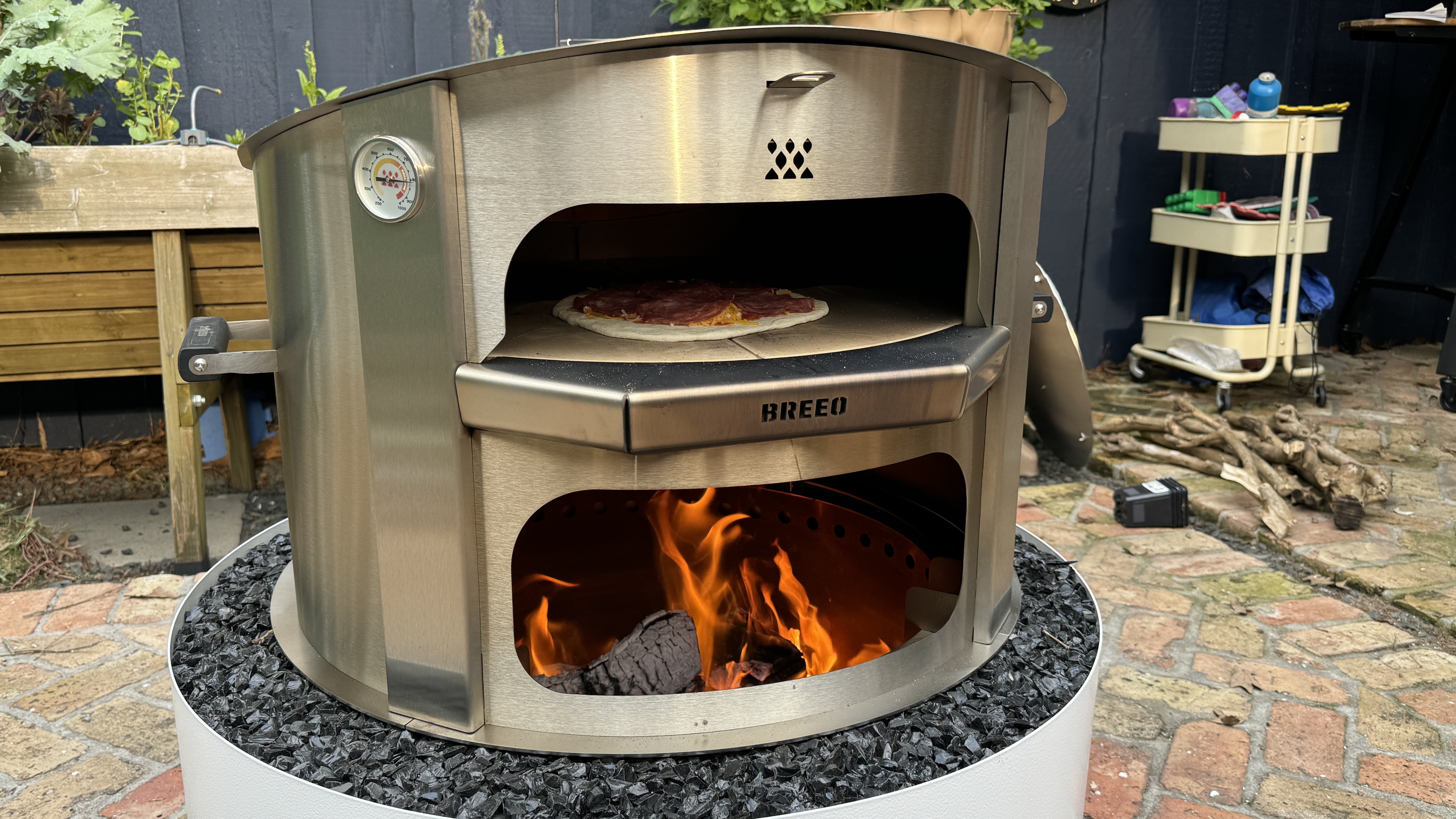 breeo live fire over a fire pit while being tested