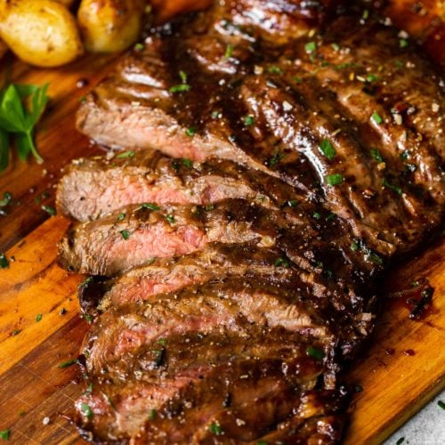a sliced flank steak that has been cooked on a gas grill with a balsamic soy sauce marinade