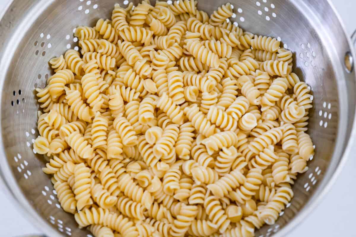 Cooked pasta in a colander. 