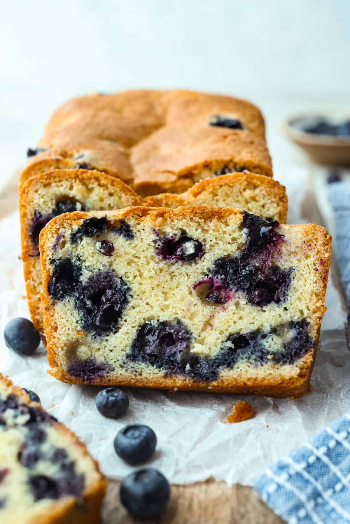 Side view of 5 ingredient blueberry bread with 2 cut slices. 