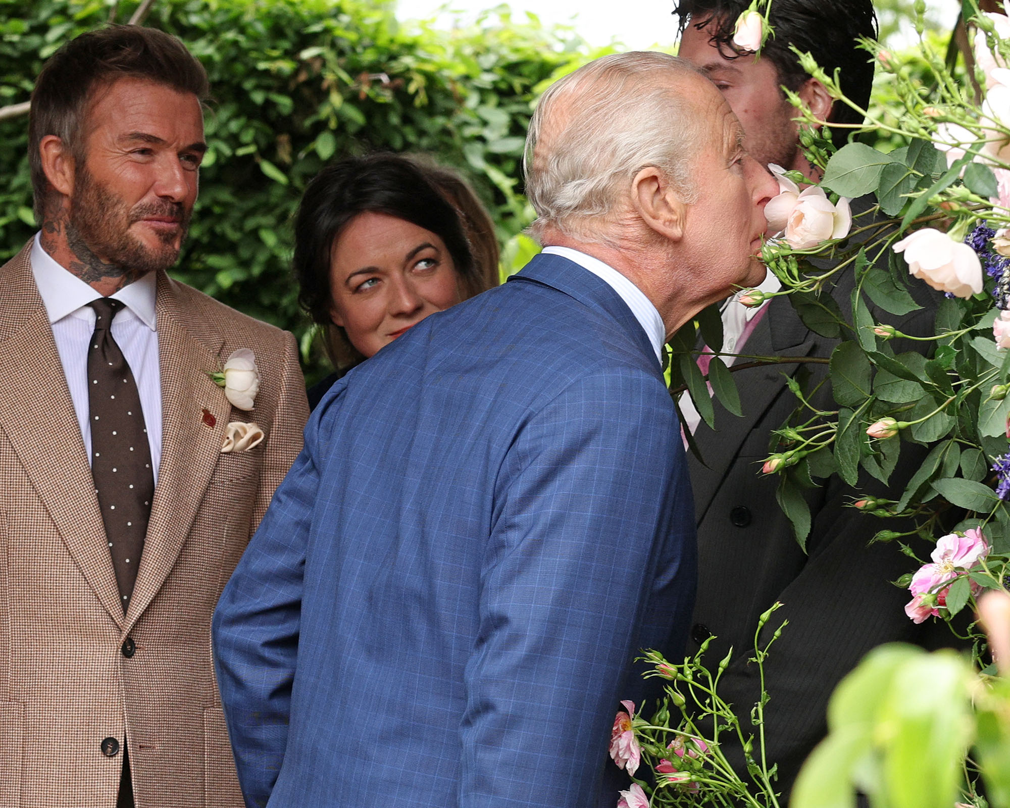 Former England footballer David Beckham and designer Frances Tophill watch King Charles III smell a Sir David Beckham Rose, by David Austin Roses, at the 2026 RHS Chelsea Flower Show