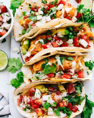Baja fish tacos lined in a row.