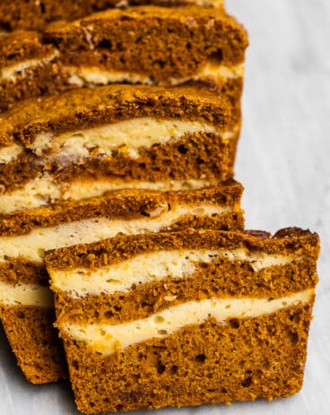 Slices of pumpkin bread with cream cheese swirls.