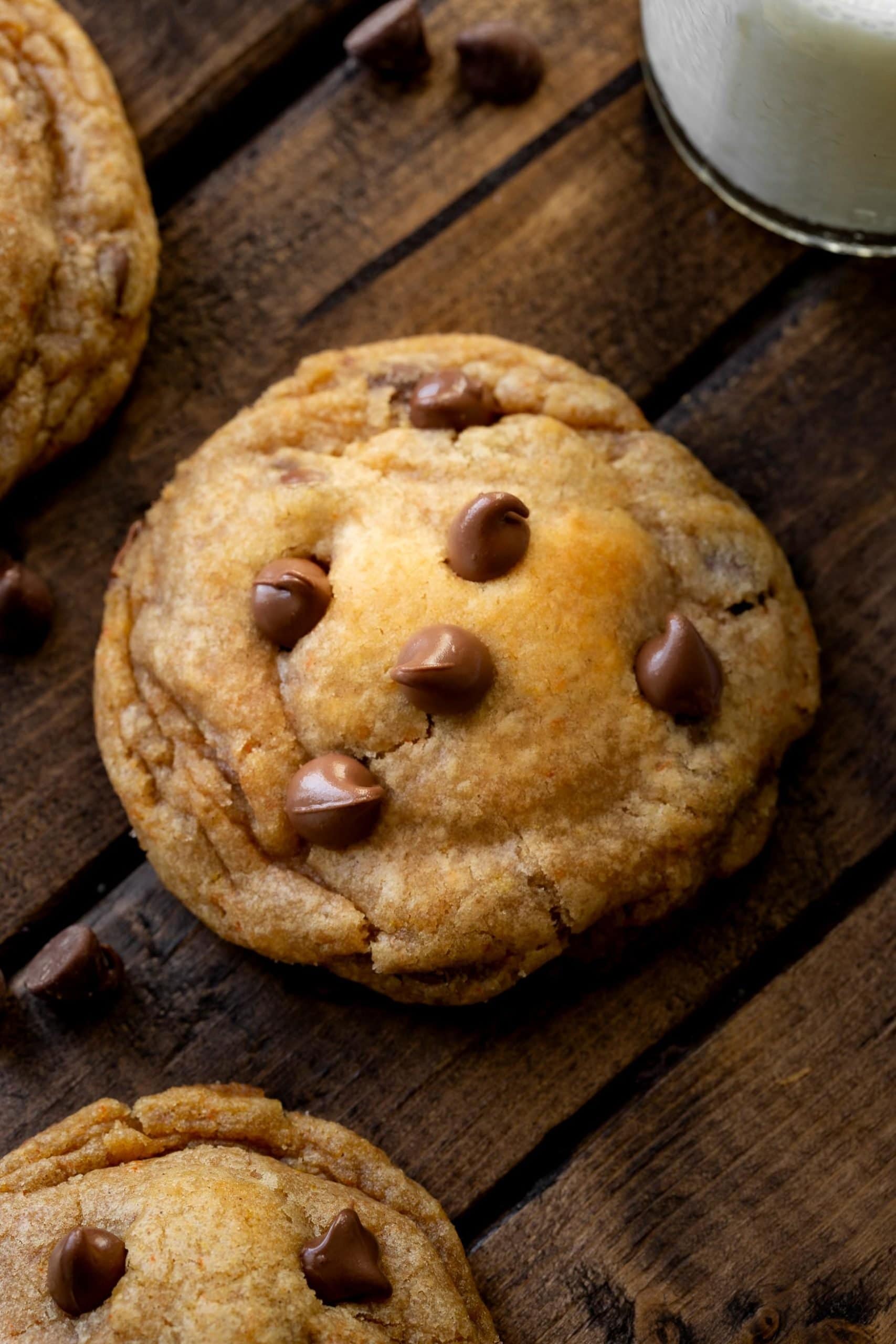 a photo of a single pumpkin pudding cookie topped with chocolate chips.