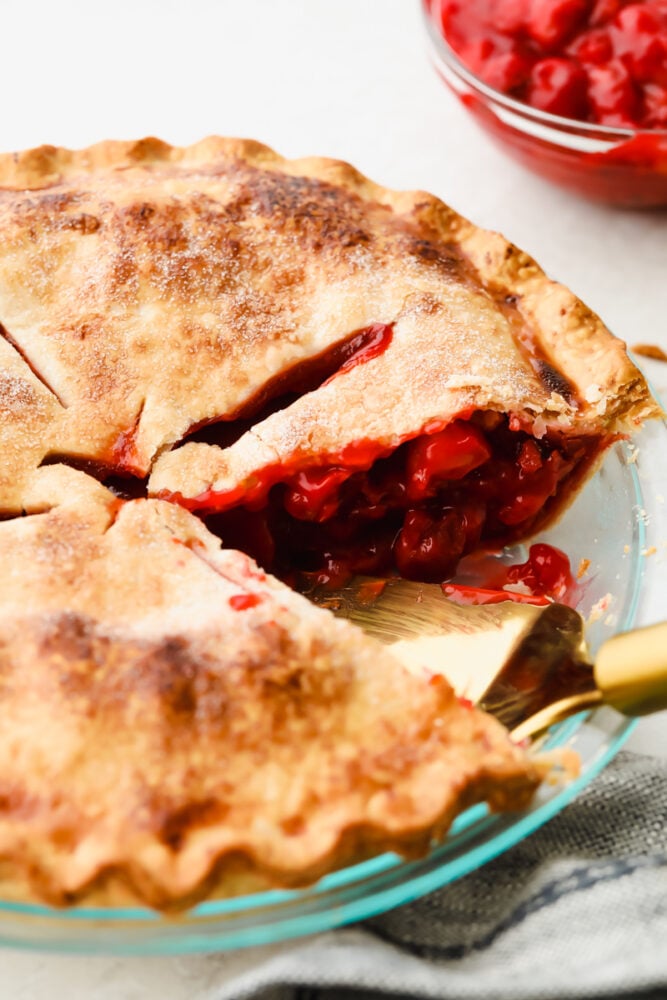 A cherry pie with a pie server.