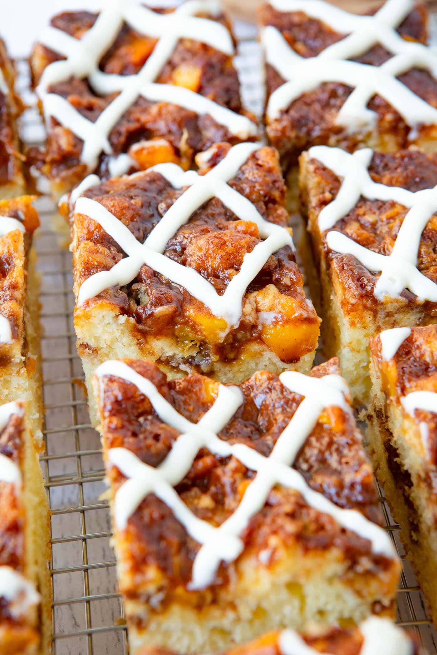 several pieces of peach coffee cake with a sweet glaze on the top