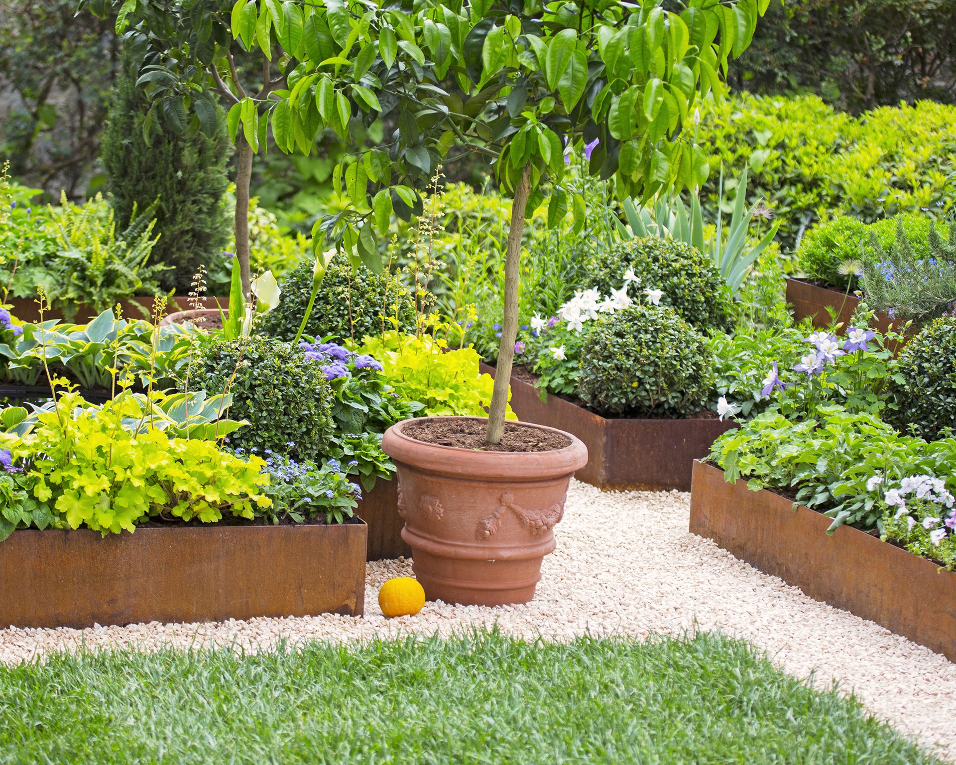 Bronzed metal raised beds in formal garden