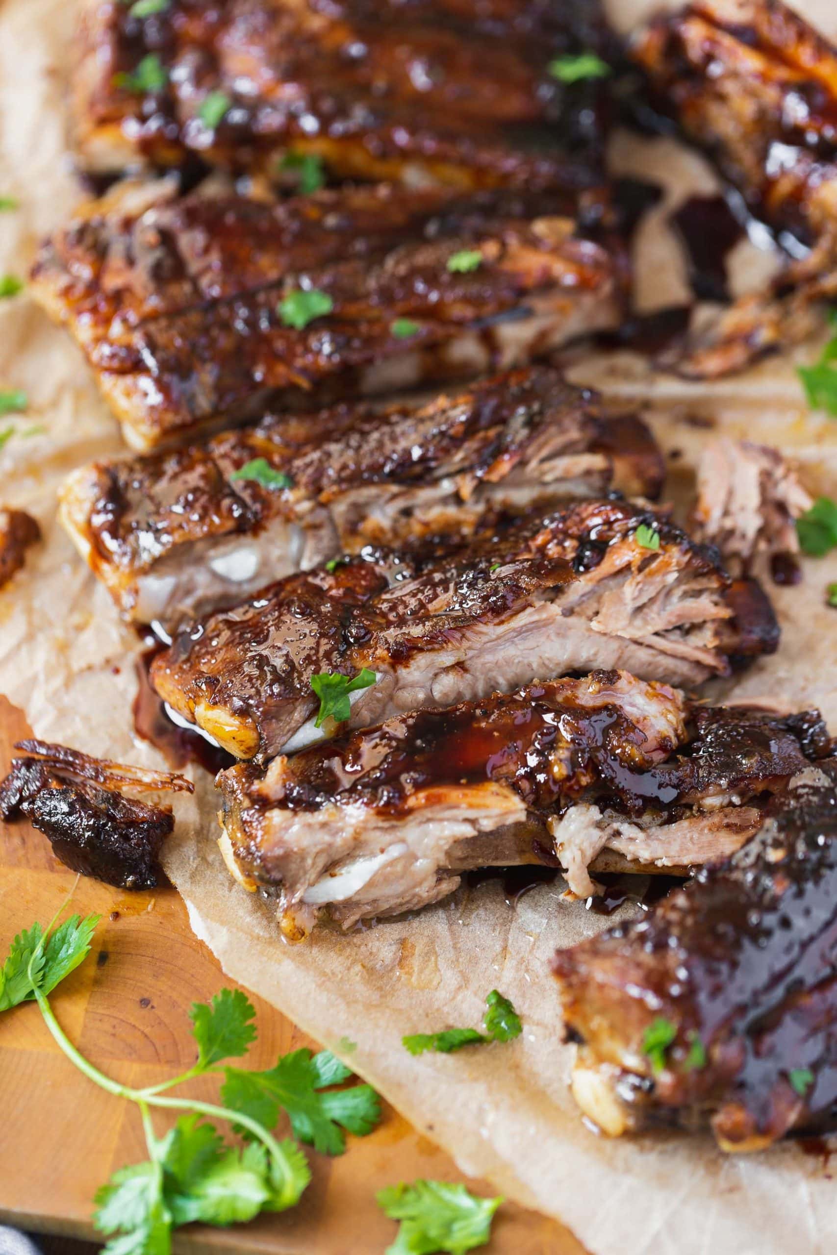 a photo of several ribs that have been cut apart that are covered in an asian sticky sauce
