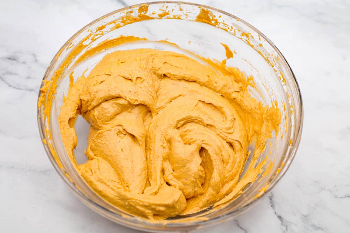 Overhead shot of pumpkin and cream cheese mixture in a glass bowl. 