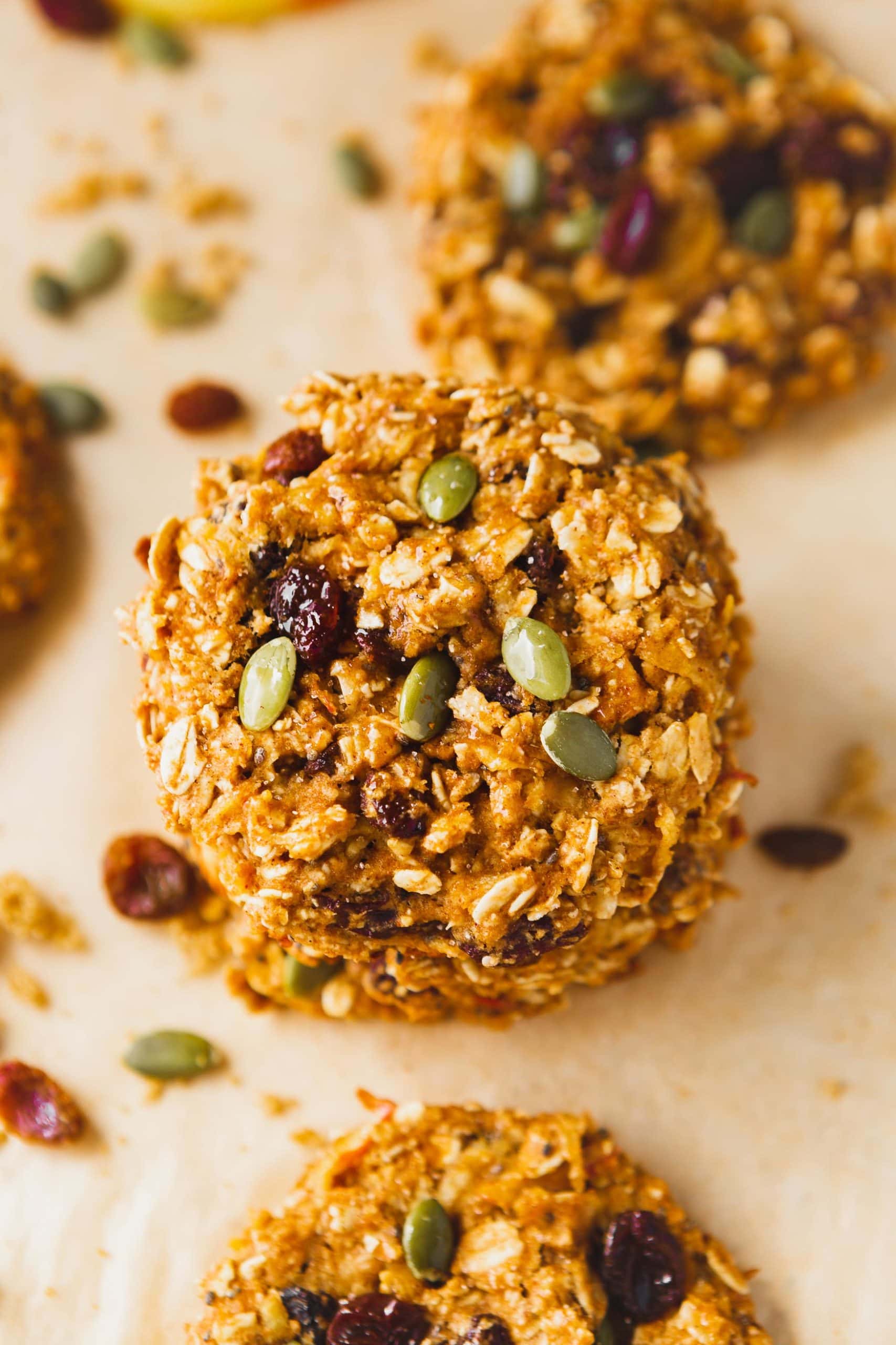 a photo of two healthy breakfast cookies stacked on each other full of raisins and pepitas