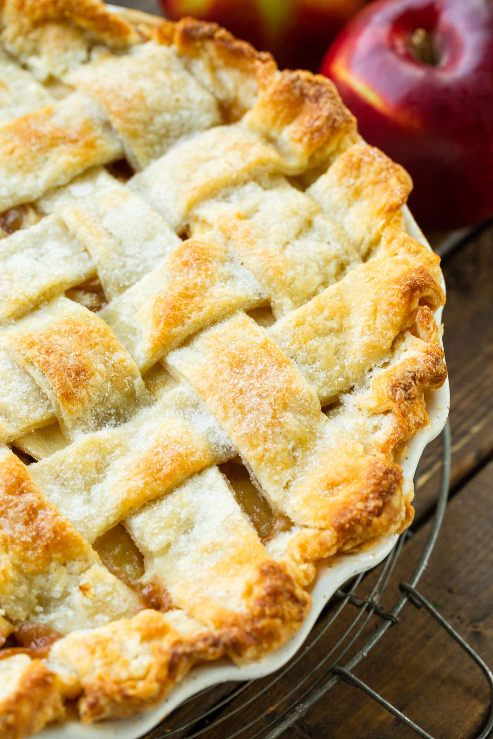 a close up photo of the top of a golden apple pie with a lattice top.