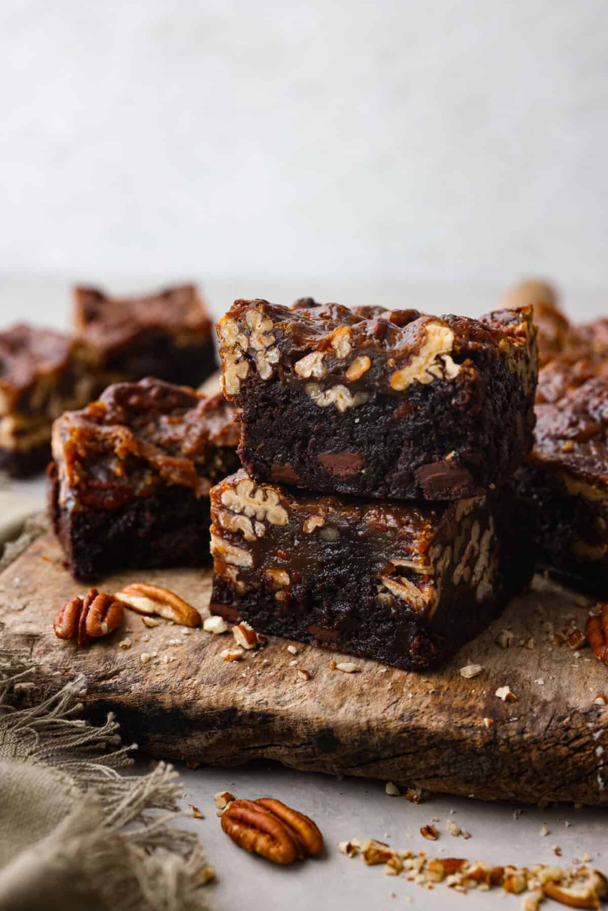 2 brownies stacked on top of each other on a serving board.