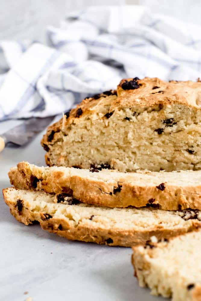 Irish soda bread slices with loaf in background