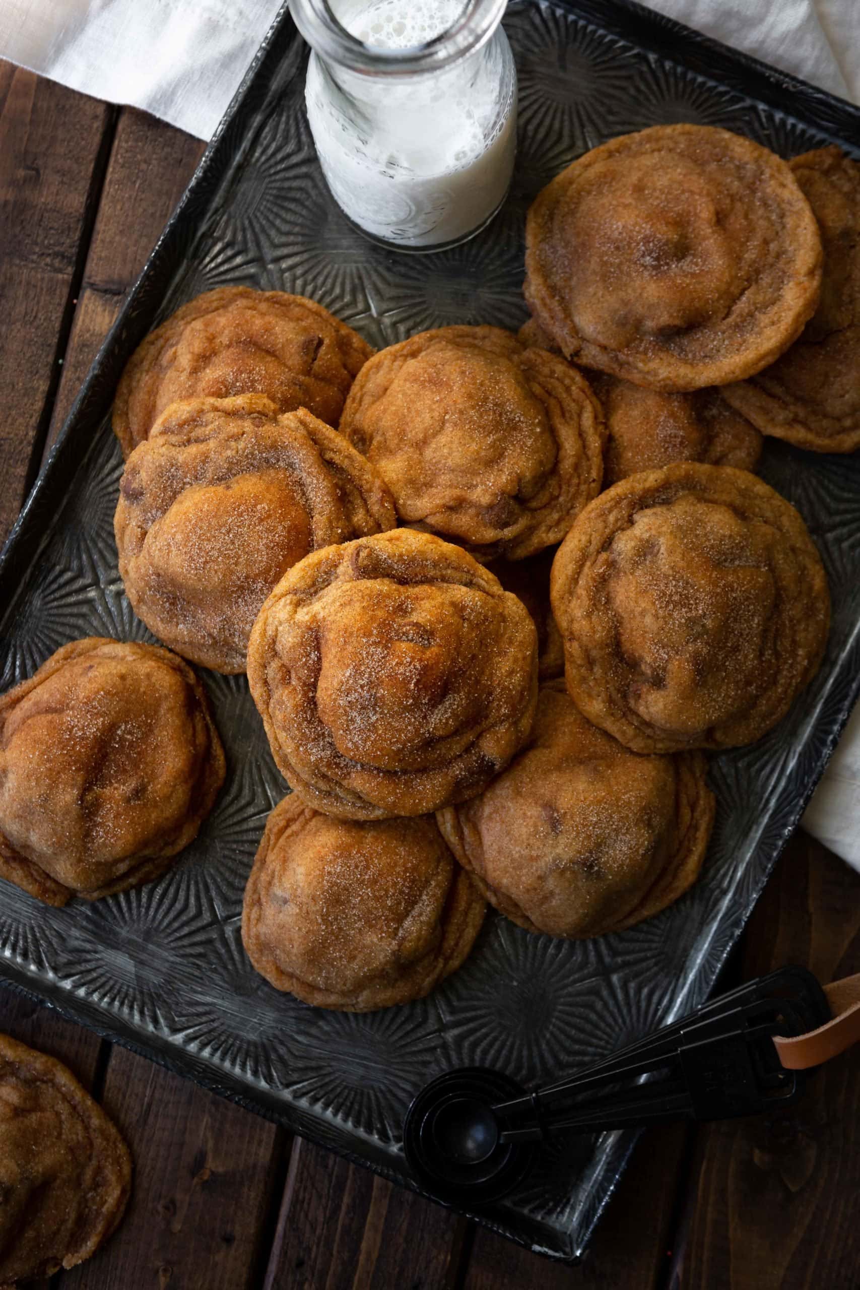 a photo of a baking sheet full of cinnamon and sugar coated pumpkin cookies.