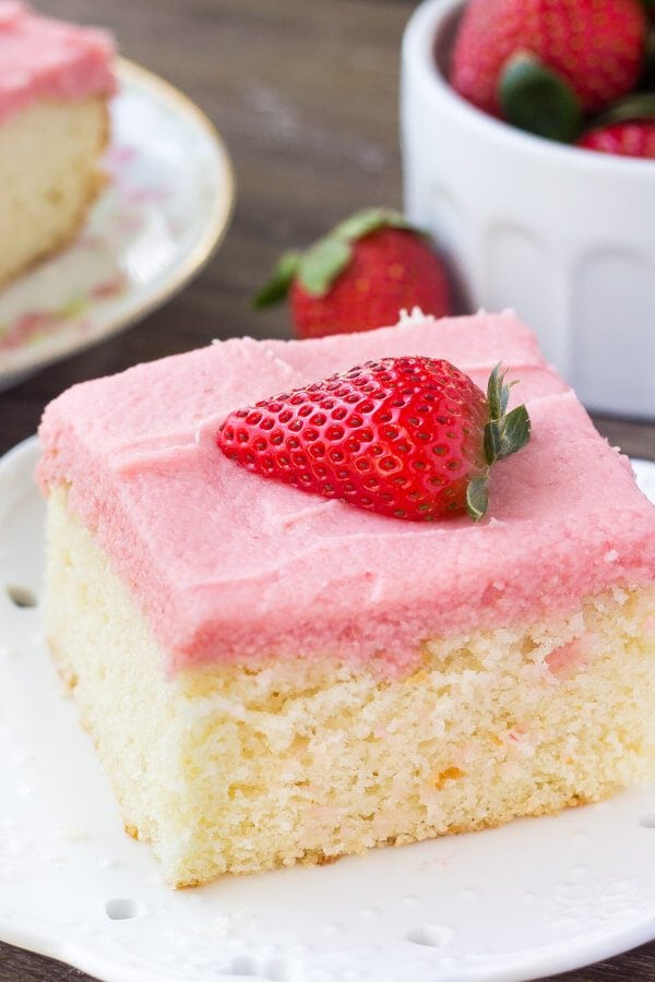 Soft, moist vanilla sheet cake topped with strawberry buttercream - you'll love the flavor combo and pretty pink color of this vanilla cake with fresh strawberry frosting.