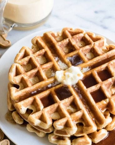 Light and fluffy waffles made with eggnog and drizzled with a homemade cinnamon syrup. 
