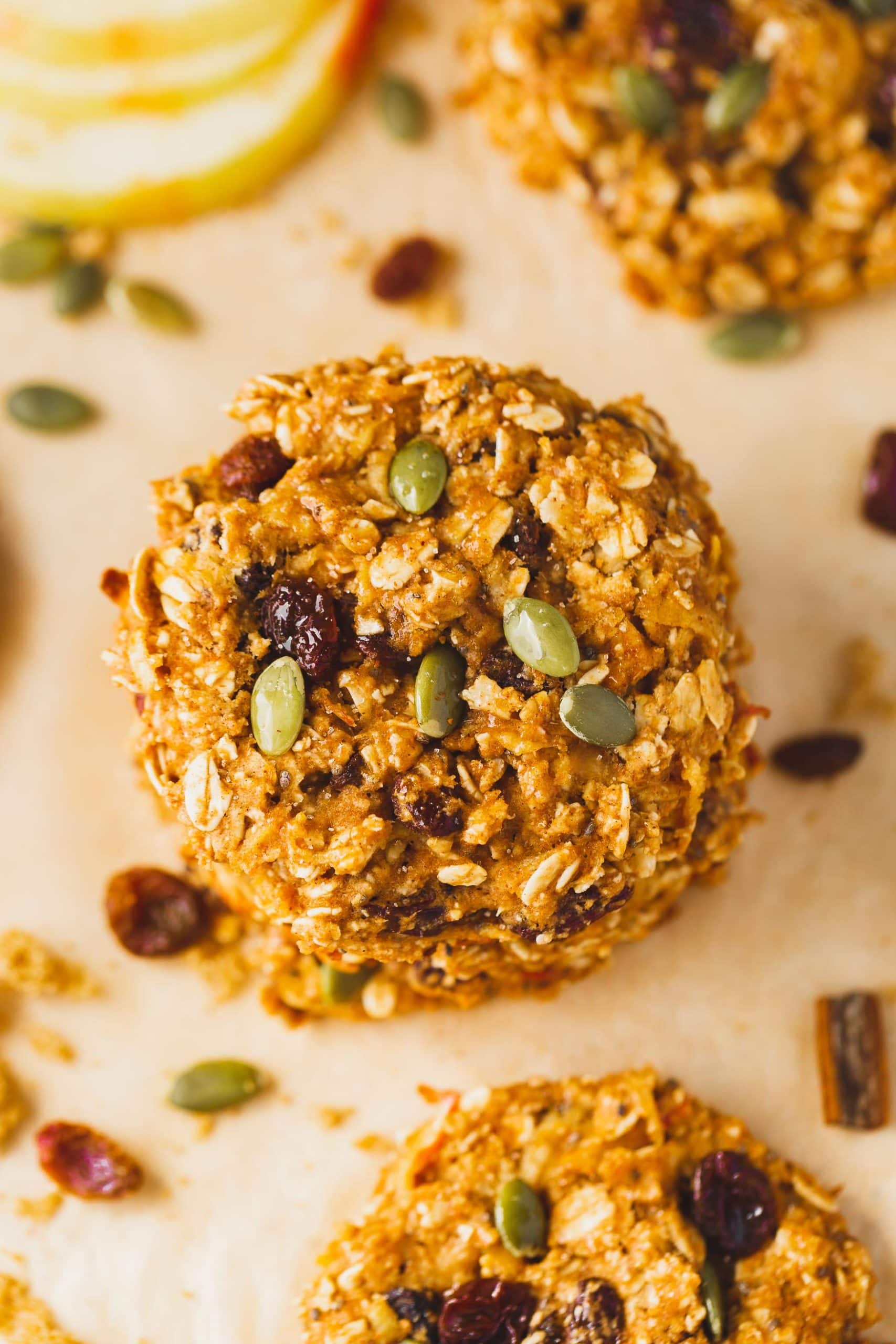 a photo of two healthy breakfast cookies stacked on each other full of raisins and pepitas