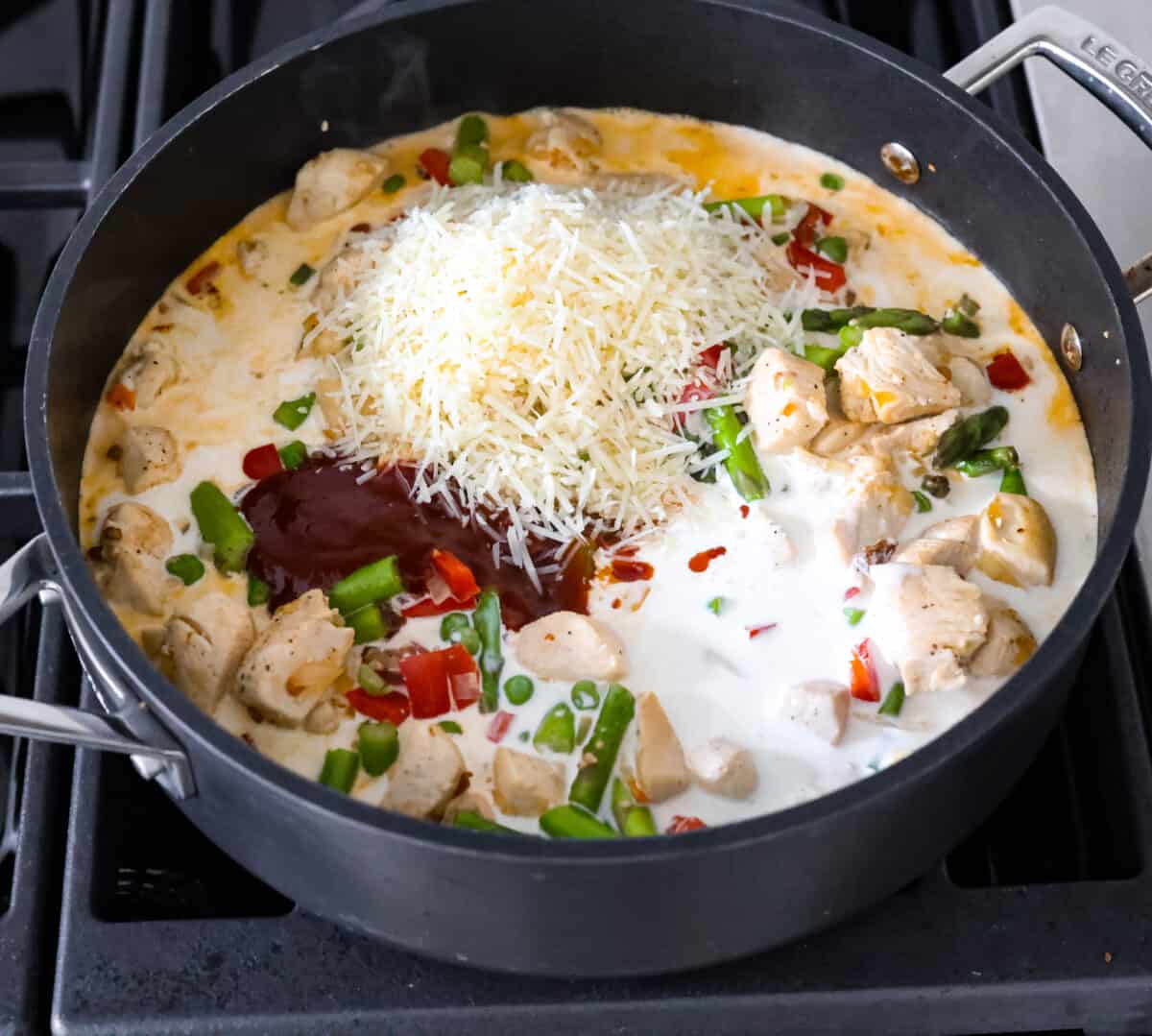 The sauce ingredients being added to the skillet.