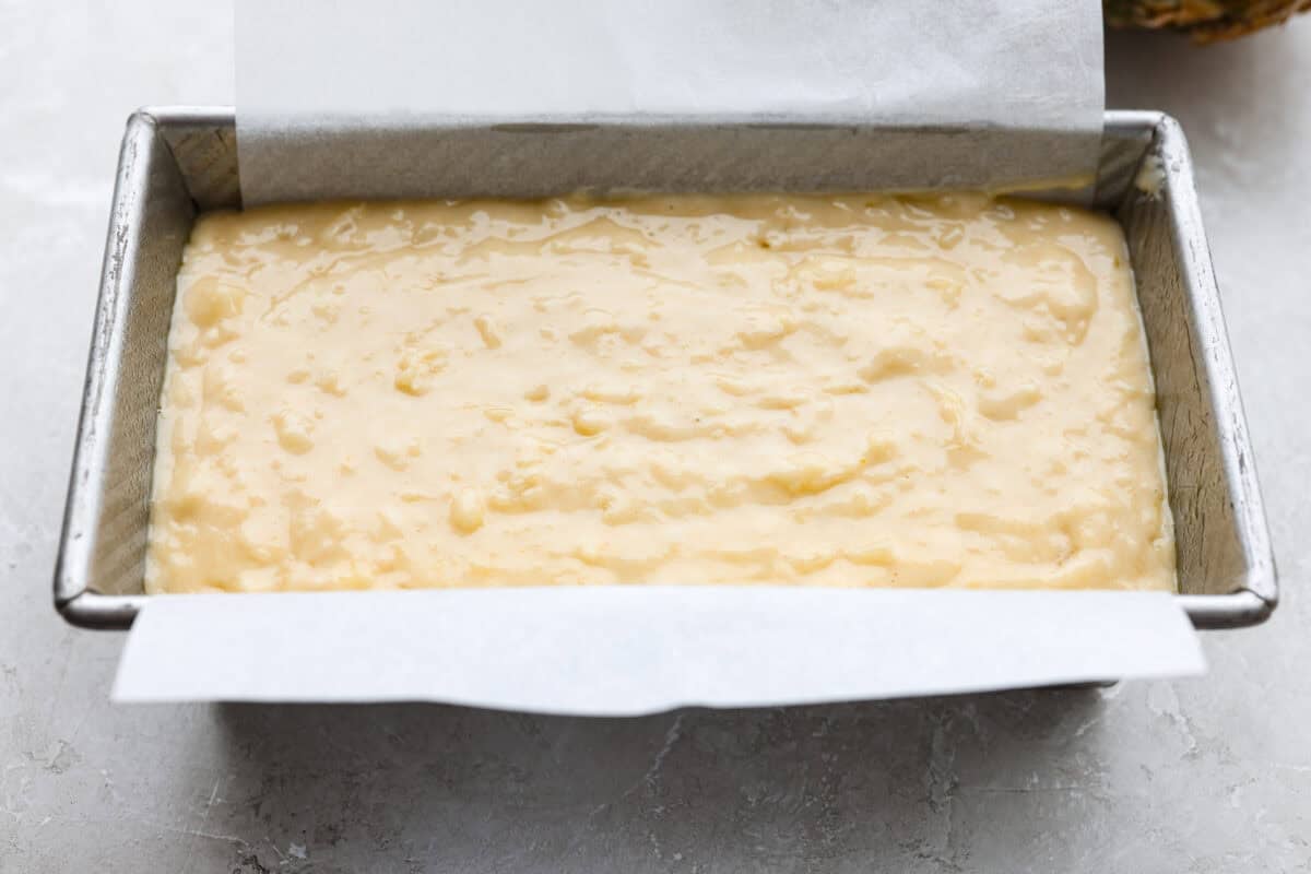 Bread batter in the cake pan. 