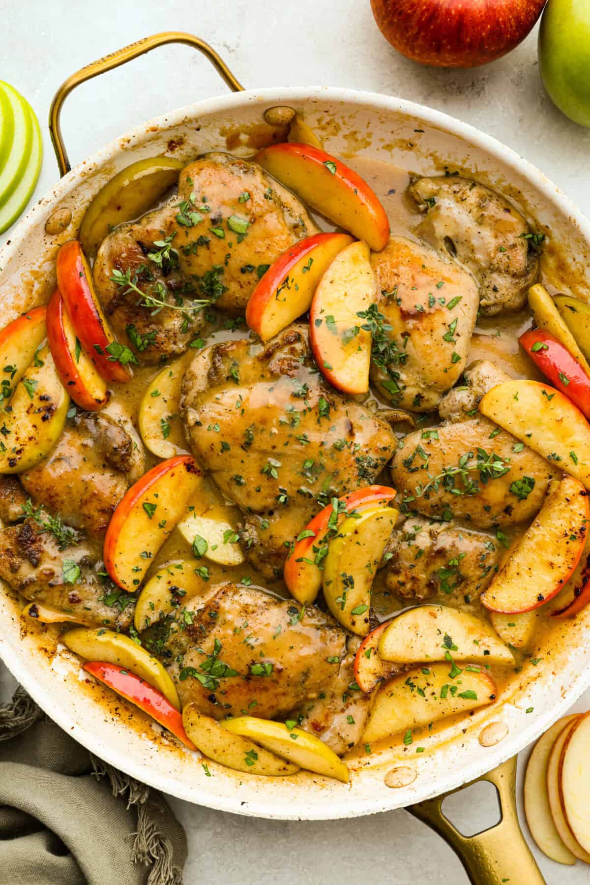 Overhead shot of apple cider chicken thighs in a skillet.