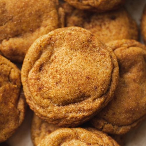 A picture of chewy pumpkin cookies with brown sugar and cinnamon on top.