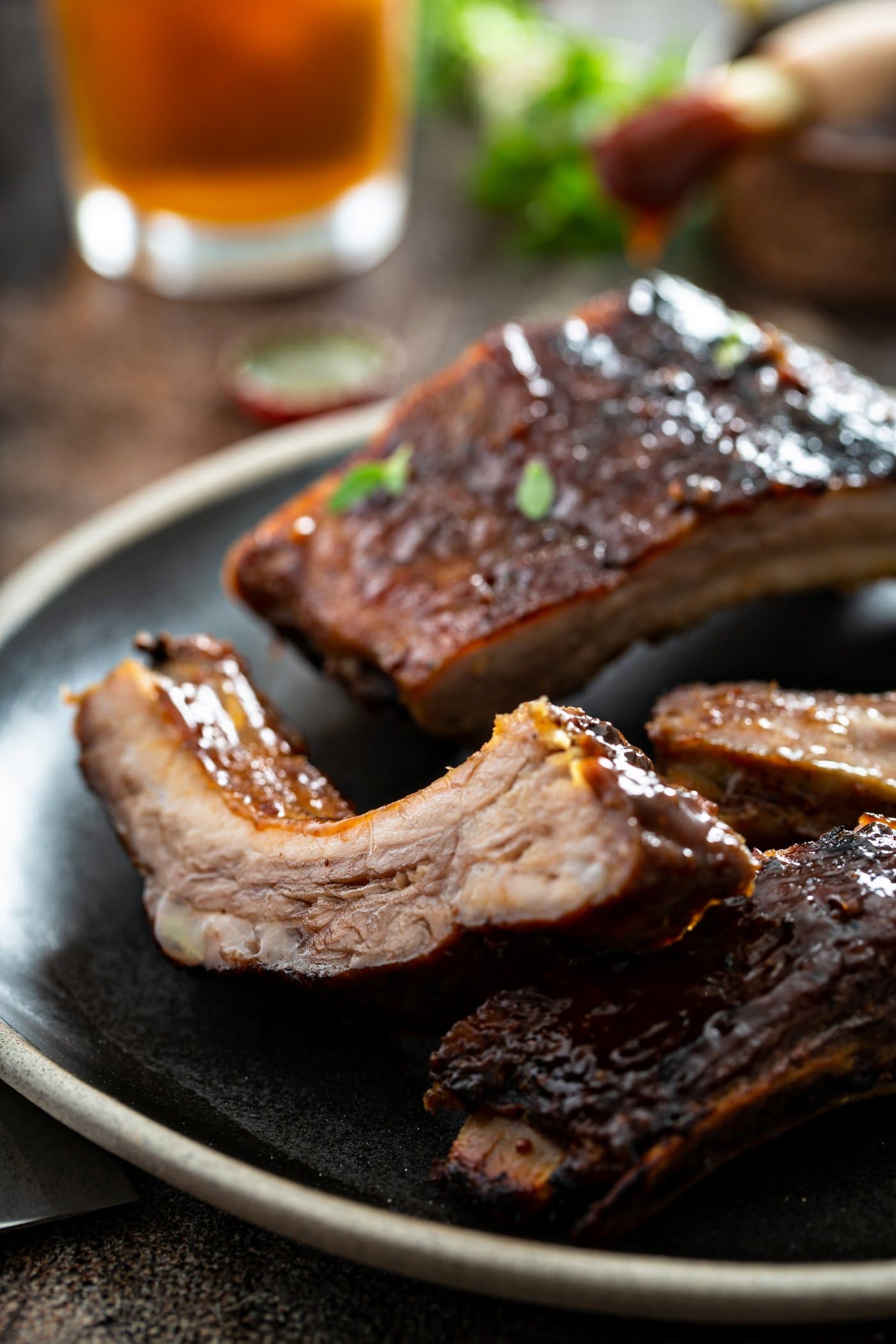 Three grilled ribs on a dinner plate.