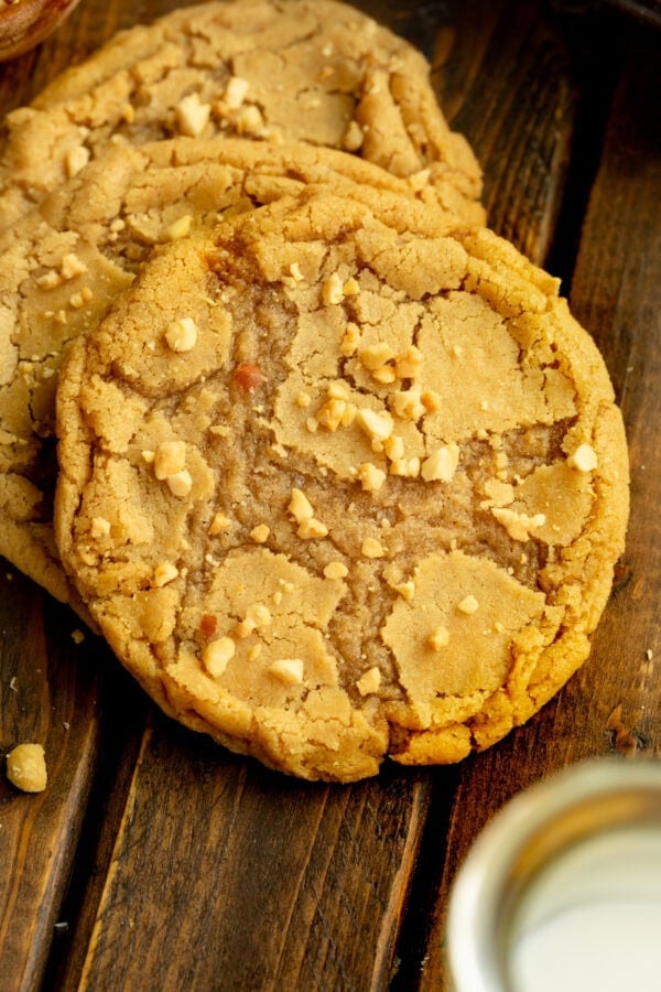 a photo of a large bakery style peanut butter cookie with chopped peanuts sprinkled on top a photo of a large bakery style peanut butter cookie with chopped peanuts sprinkled on top