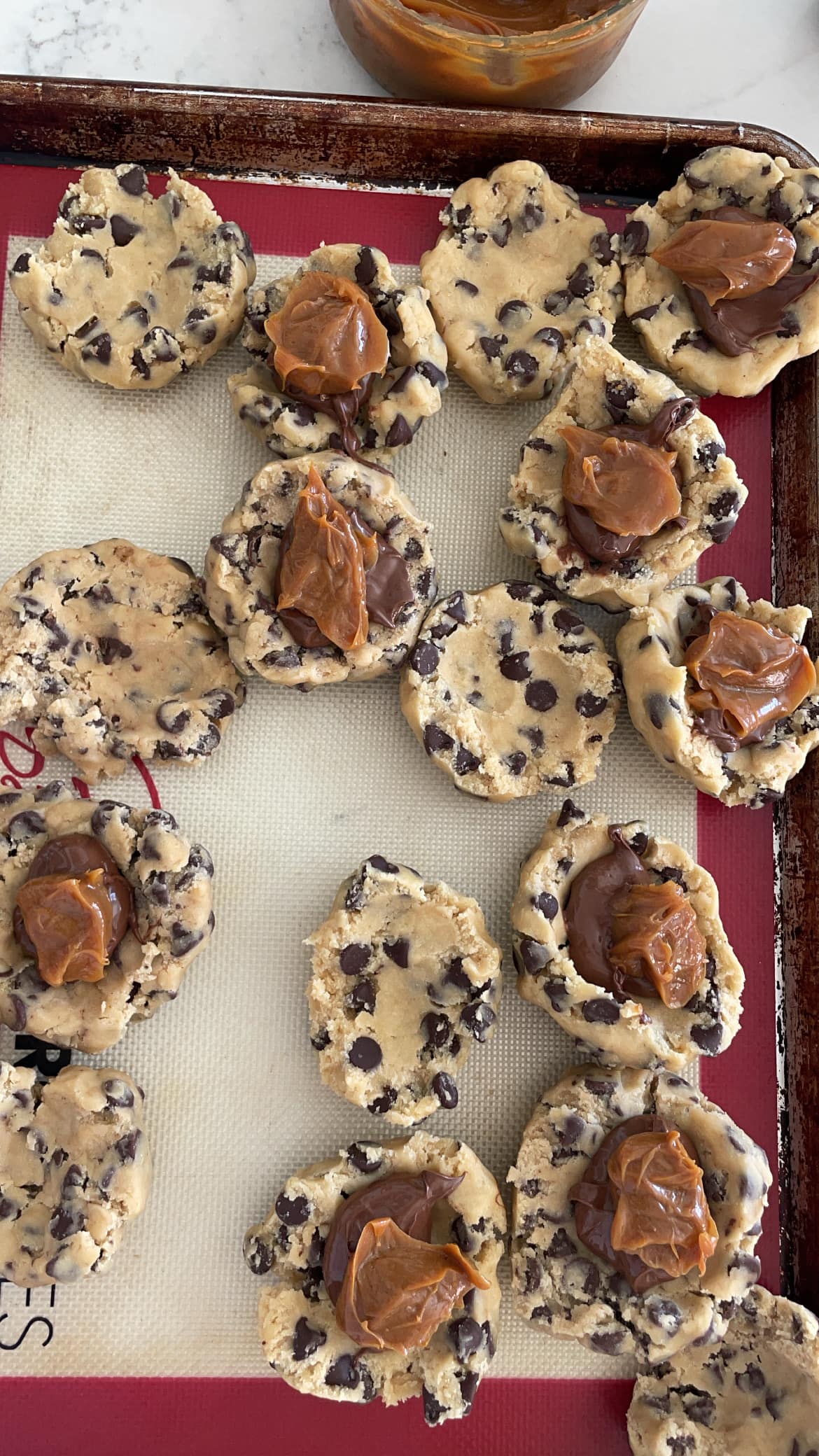 nutella and dulce de leche scooped into chocolate chip cookie dough nutella and dulce de leche scooped into chocolate chip cookie dough