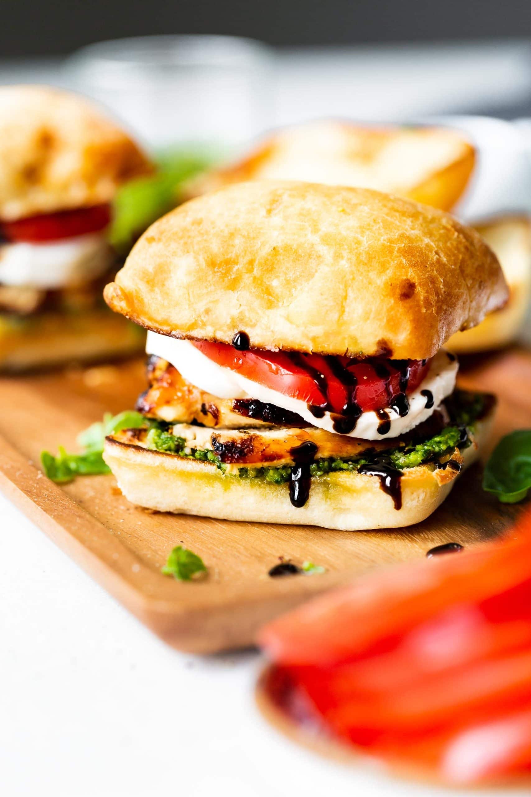 a photo of a chicken caprese sandwich on a ciabatta roll with a layer of pesto, chicken, fresh mozzarella, tomato and balsamic glaze. a photo of a chicken caprese sandwich on a ciabatta roll with a layer of pesto, chicken, fresh mozzarella, tomato and balsamic glaze.