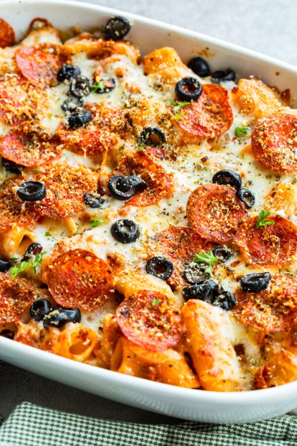 a photo of a cheesy pepperoni pasta casserole topped with sliced olives and melted cheese a photo of a cheesy pepperoni pasta casserole topped with sliced olives and melted cheese