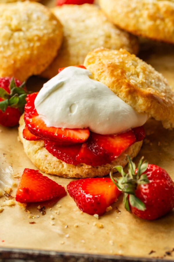 a photo of a golden sweet biscuit filled with juicy strawberry slices and fluffy whipped cream a photo of a golden sweet biscuit filled with juicy strawberry slices and fluffy whipped cream