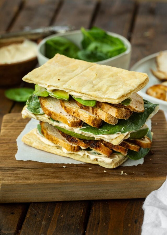a photo of a double stacked grilled chicken and avocado napoleon sandwich a photo of a double stacked grilled chicken and avocado napoleon sandwich