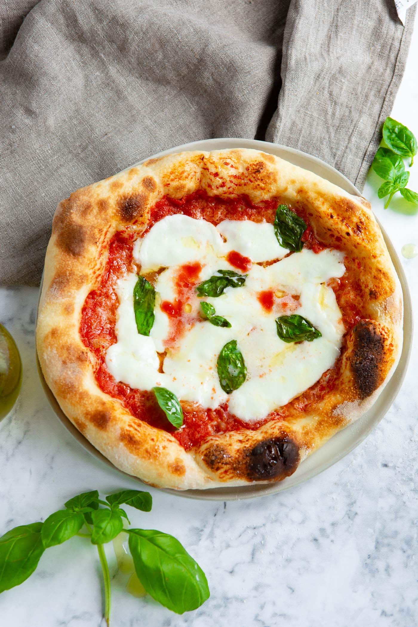 homemade margherita pizza with fresh basil leaves homemade margherita pizza with fresh basil leaves