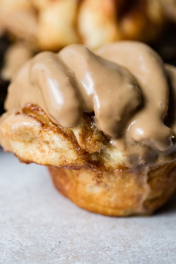 A close up of a cinnamon butterflake roll with maple glaze A close up of a cinnamon butterflake roll with maple glaze
