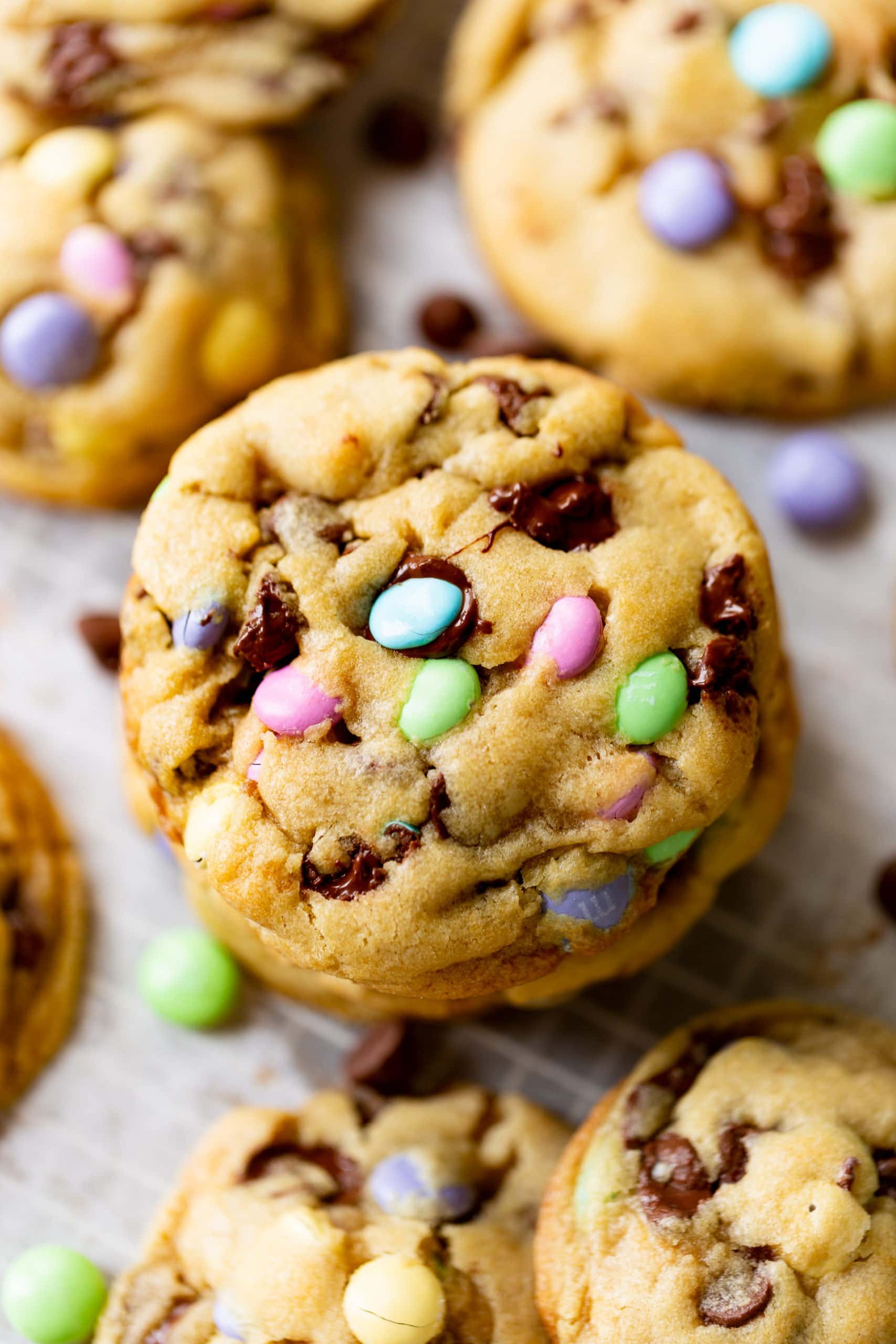 a photo of a stack of golden baked Easter m&m chocolate chipe cookies taken straight above the stack of cookies. a photo of a stack of golden baked Easter m&m chocolate chipe cookies taken straight above the stack of cookies.