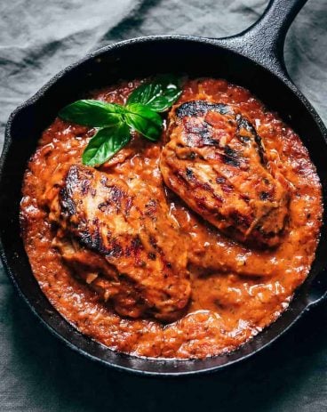 Creamy tomato basil chicken in a cast iron skillet ready to be served Creamy tomato basil chicken in a cast iron skillet ready to be served